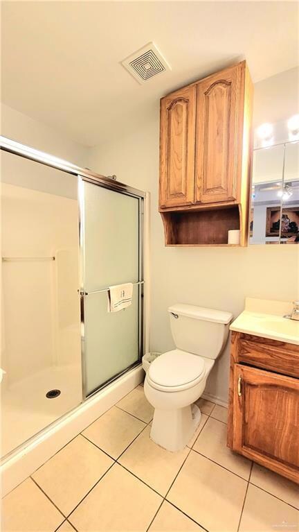 Bathroom with vanity, tile patterned flooring, a stall shower, and visible vents
