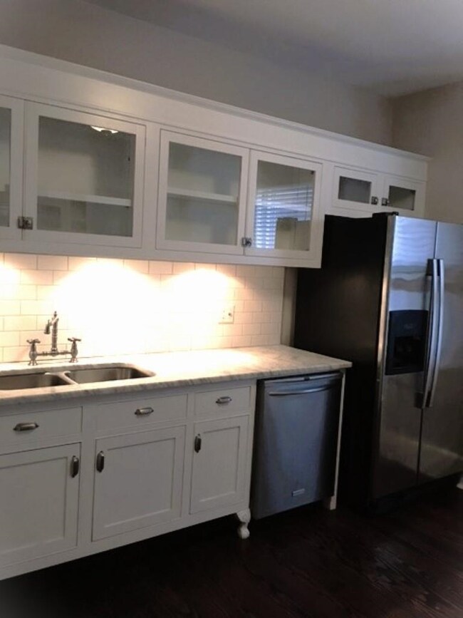 Kitchen with decorative backsplash, appliances wit