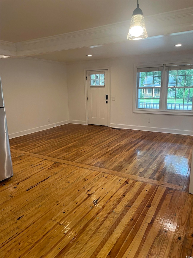 Entryway featuring dark wood-style flooring, ornamental molding, and recessed lighting