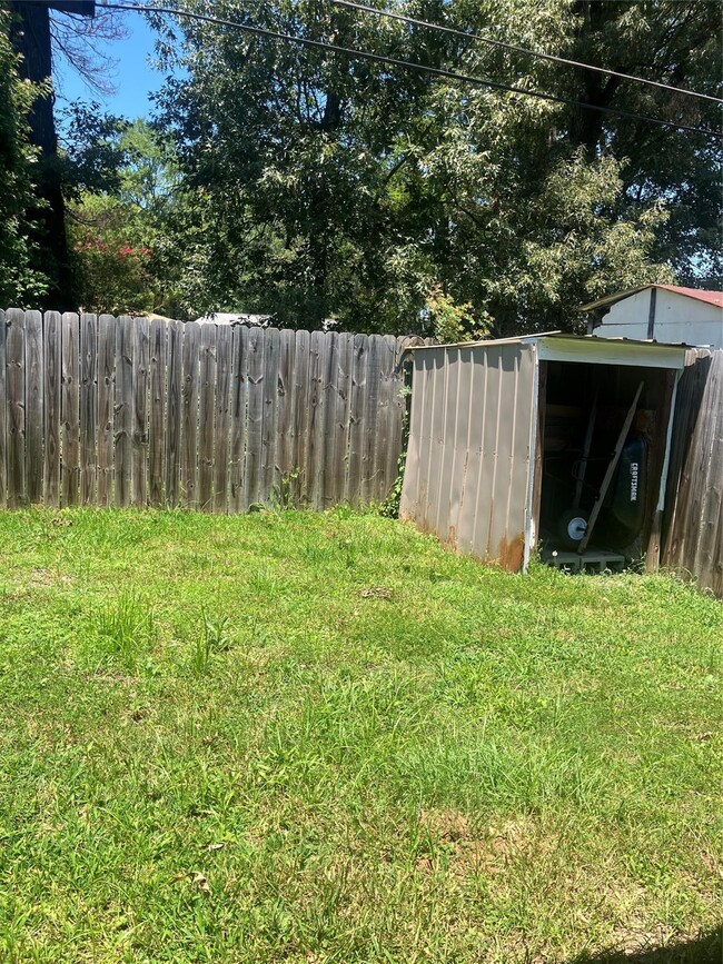 View of yard featuring a storage unit