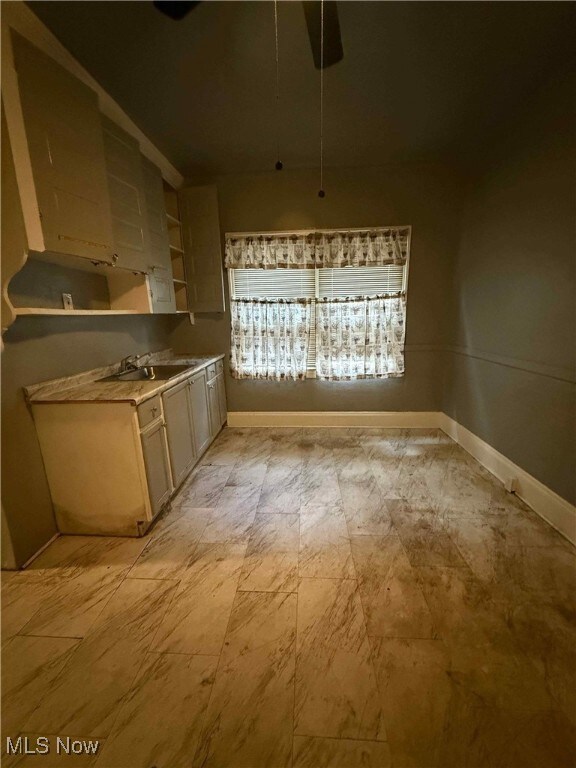 Kitchen featuring light countertops and a ceiling fan