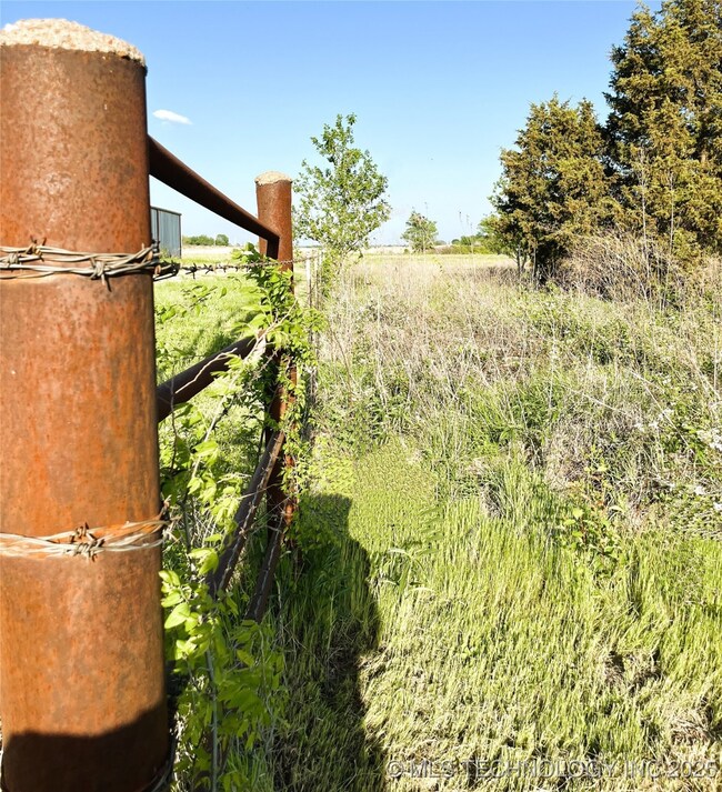 SW Corner of barbed wire fence near North property