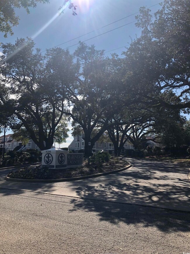 View of asphalt road with curbs and a residential view