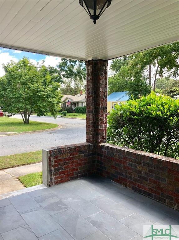 Open air porch with slate flooring and freshly pai
