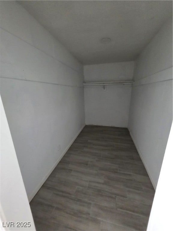 Hall featuring wood finished floors and baseboards