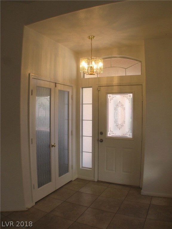 Entry Foyer with double doors in to den/3rd bedroo