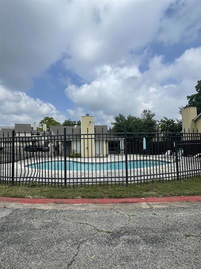 Community pool featuring fence