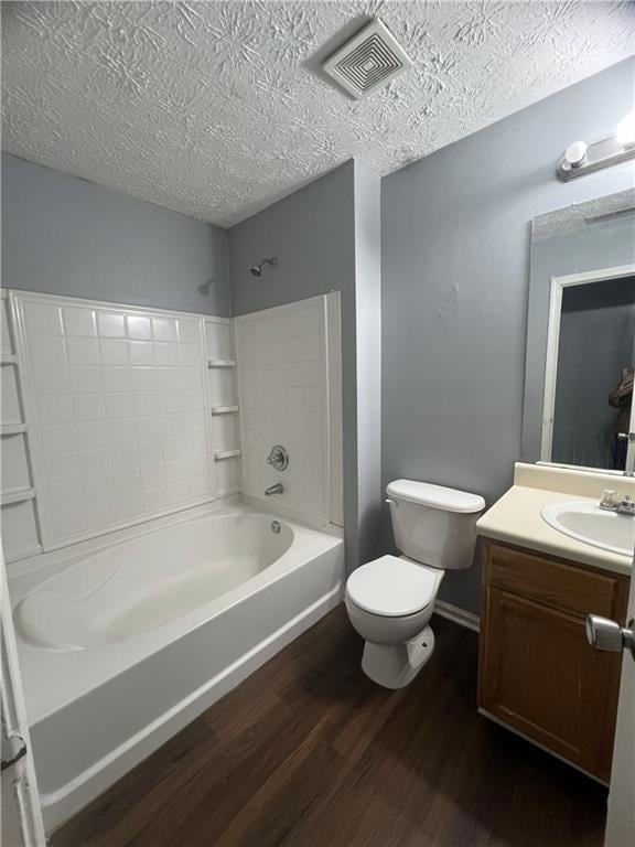 Bathroom with wood finished floors, toilet, vanity