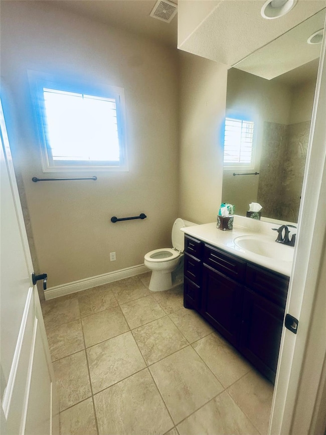 Bathroom with tile patterned flooring, toilet, an