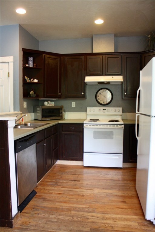 Another view of kitchen showing hardwood floors an