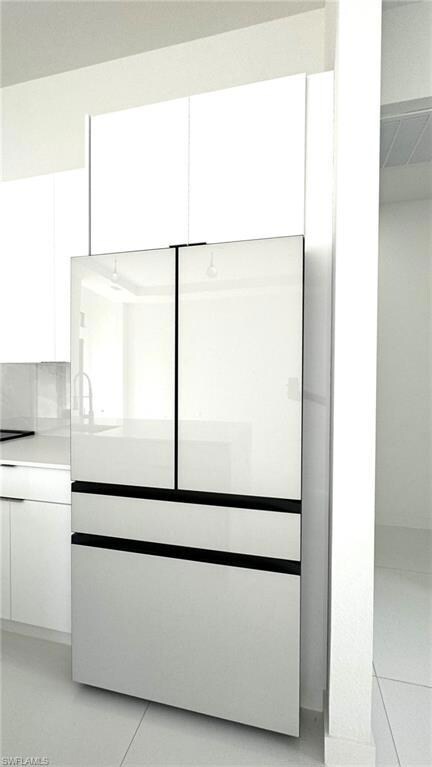 Room details with built in refrigerator and tile patterned flooring