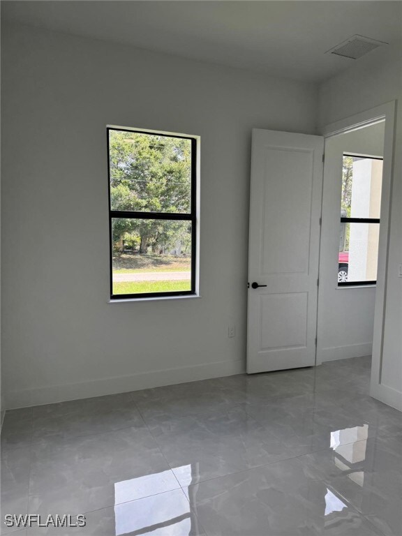 Unfurnished room with healthy amount of natural li