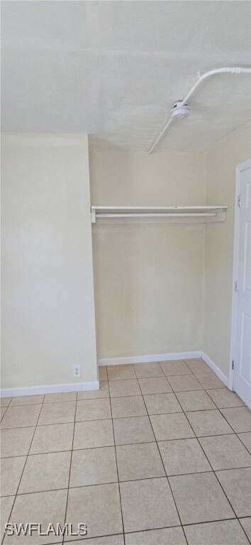 Walk in closet featuring light tile patterned floors