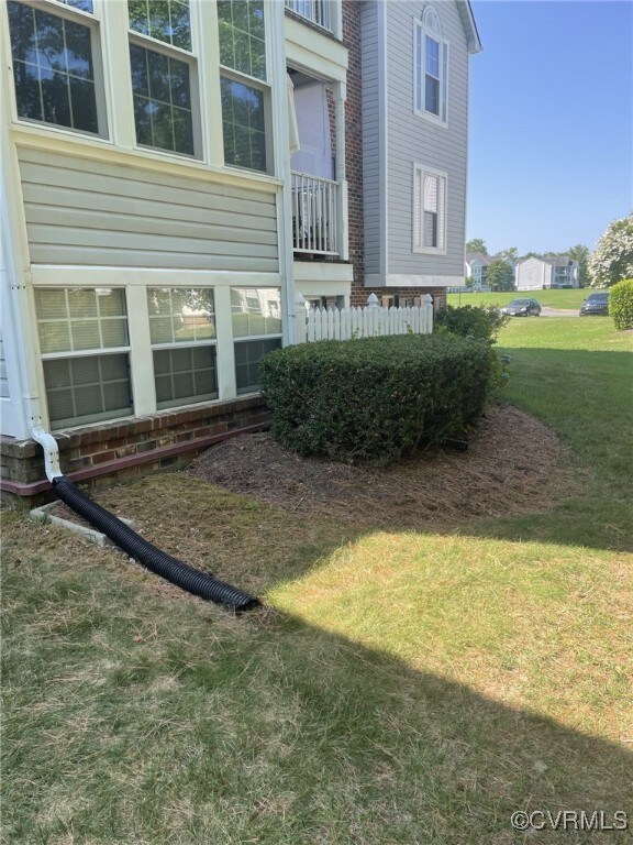 View of side of home featuring a yard