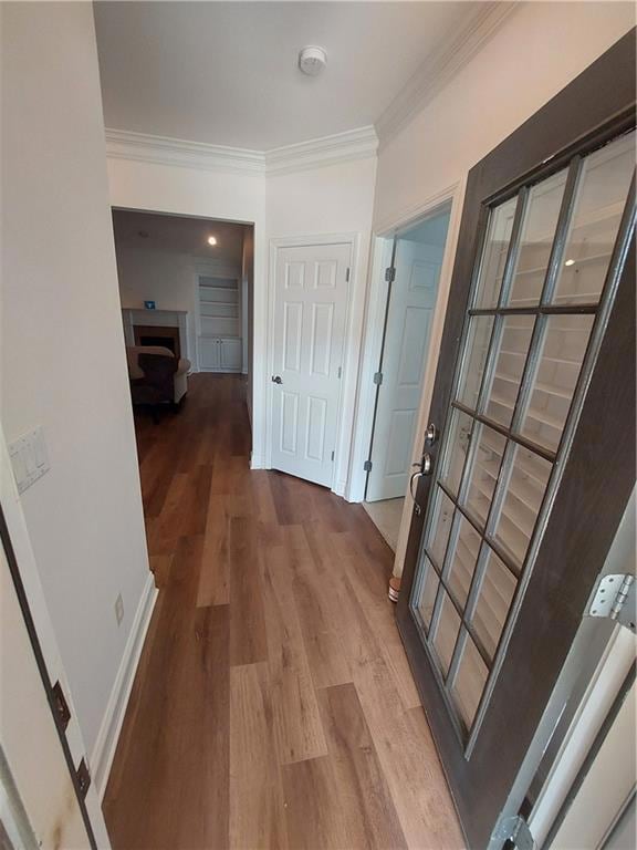 Corridor with baseboards, wood finished floors, an