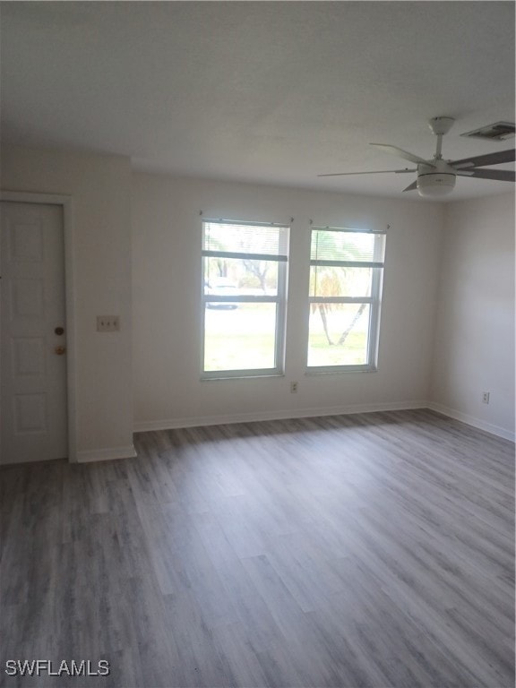 Unfurnished room with visible vents, baseboards, w