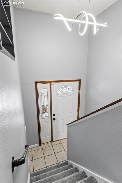Entryway with light tile patterned flooring