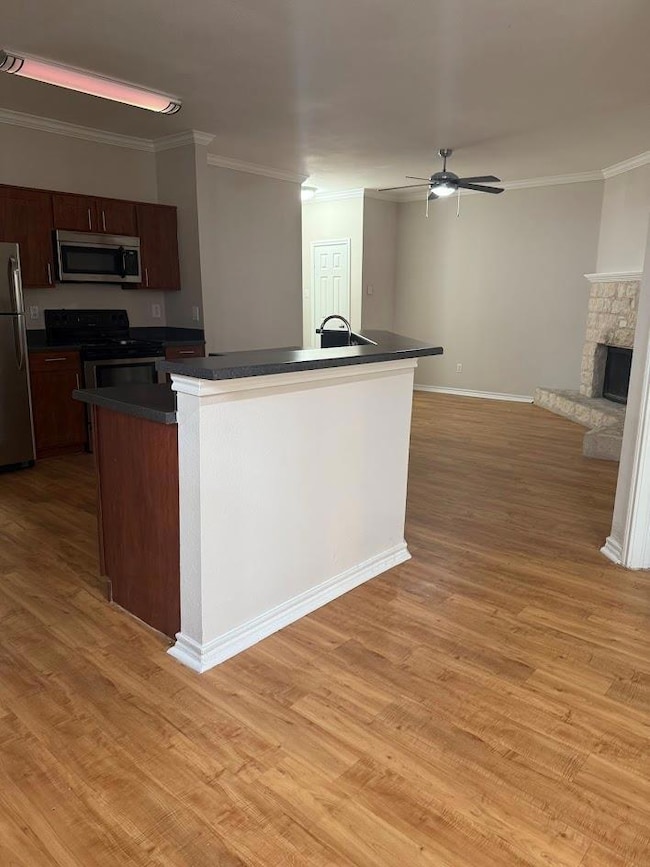 Kitchen with stainless steel appliances, dark cou