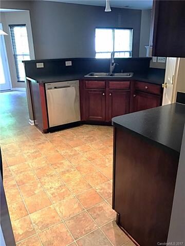 View from the dining room through the kitchen to the breakfast nook.  Note that the high countertops behind the sink are great for barstools.