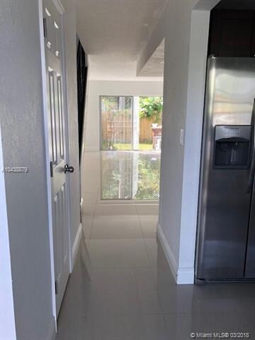 HALL TO THE LIVING ROOM AND KITCHEN ENTRANCE