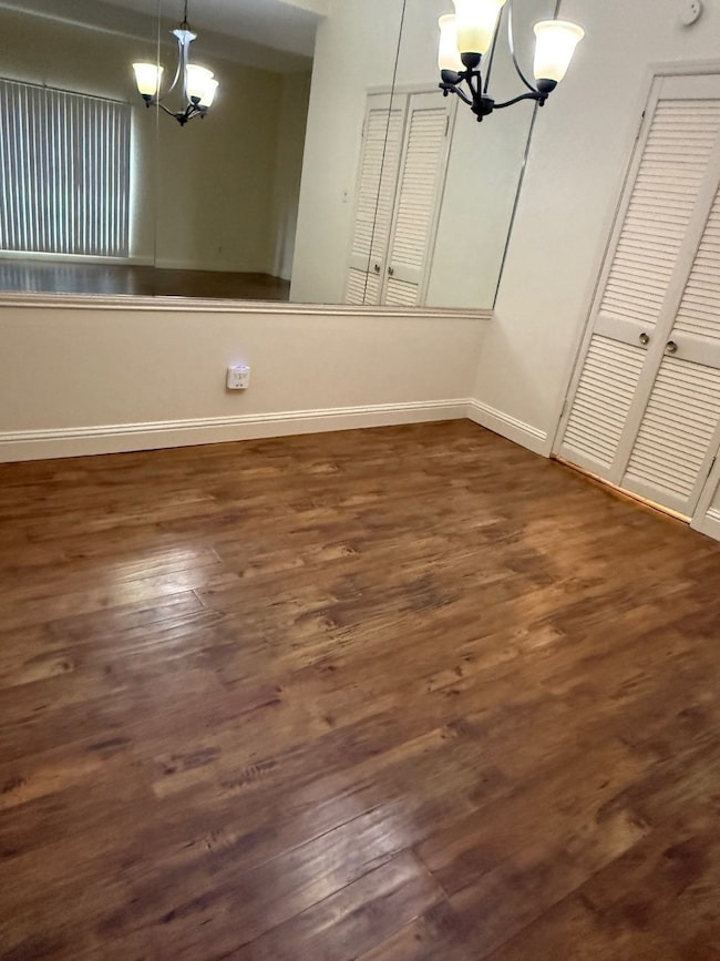 Dining area featuring a chandelier and wood finished floors