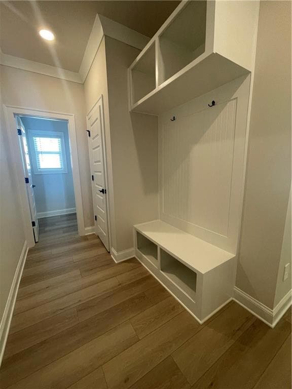 Mudroom featuring baseboards, crown molding, and w