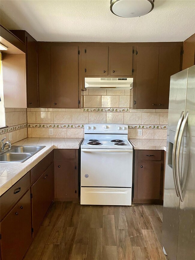 Kitchen featuring stainless steel fridge, white r