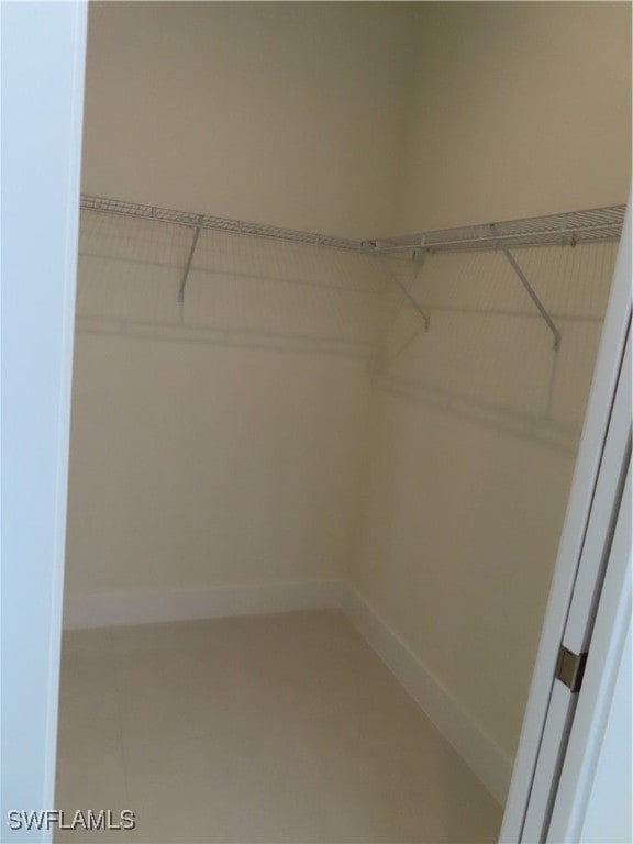 Walk in closet featuring tile patterned floors
