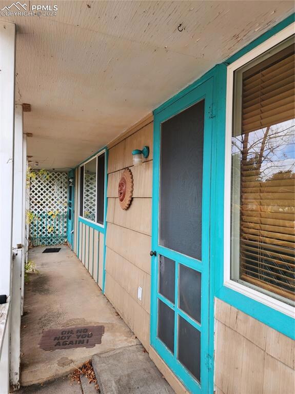 covered front porch with 2 entry doors