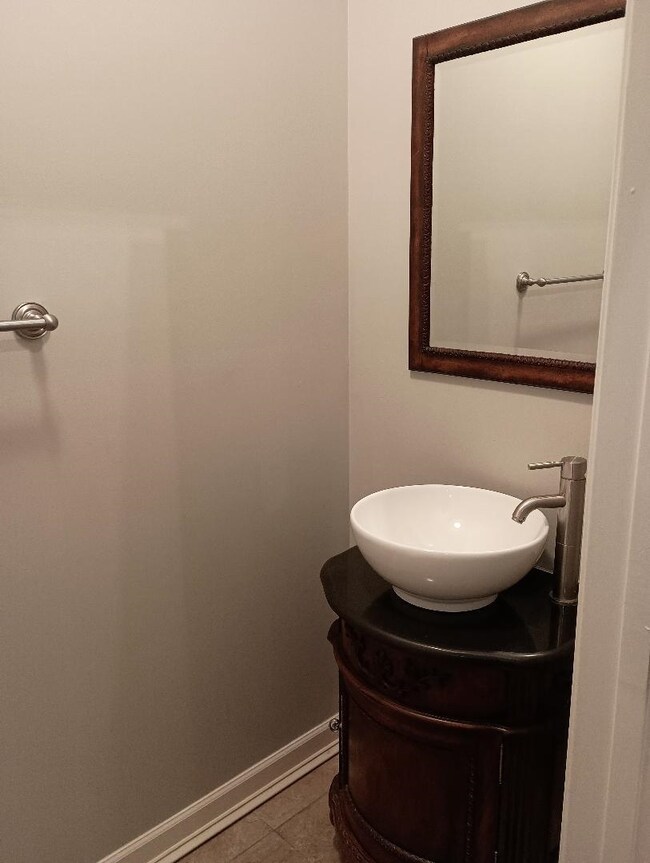 Bathroom with tile patterned flooring and vanity