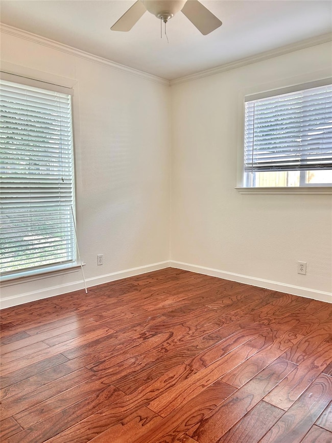 Spare room featuring crown molding, a ceiling fan