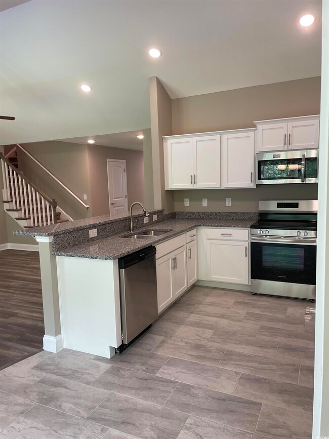 Kitchen featuring stainless steel appliances, sink