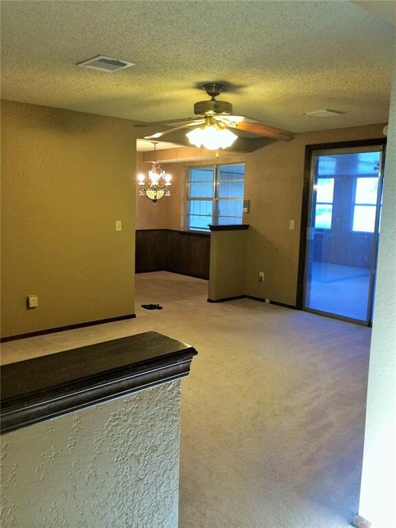 Nice sized living area with ceiling fan, open to kitchen and access to heated/cooled sun room!