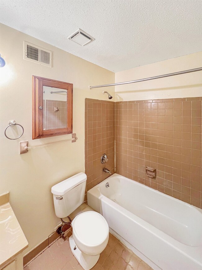 Bathroom featuring visible vents, vanity, toilet, 