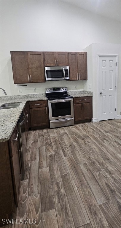 Kitchen featuring stainless steel appliances, a si
