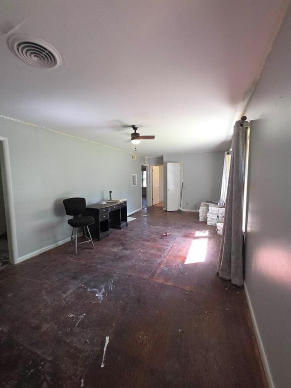 Living room featuring baseboards and a ceiling fan
