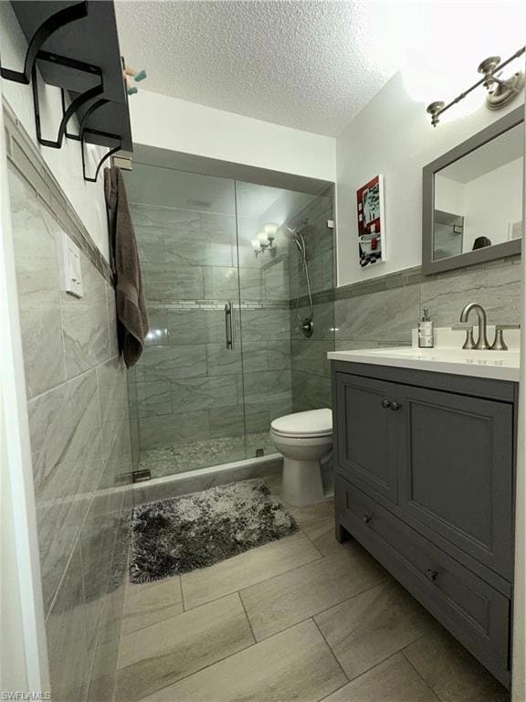 Full bathroom with tile walls, a textured ceiling,