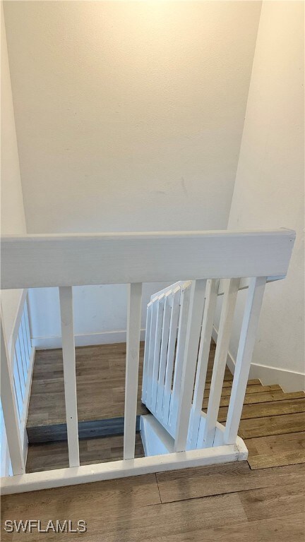 Stairs featuring wood finished floors