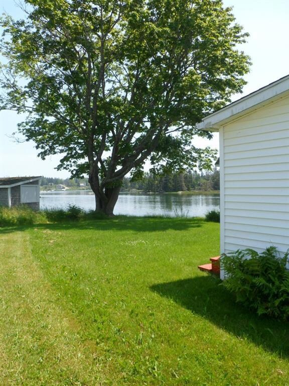 Lovely back yard with waterfront on...
