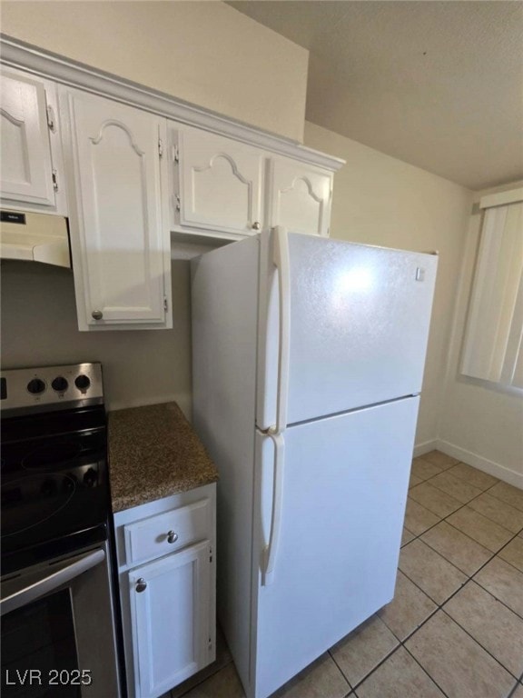 Kitchen featuring freestanding refrigerator, elect