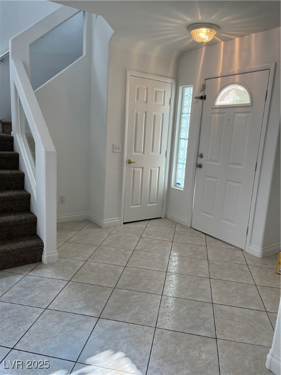 Foyer entrance featuring light tile patterned floo