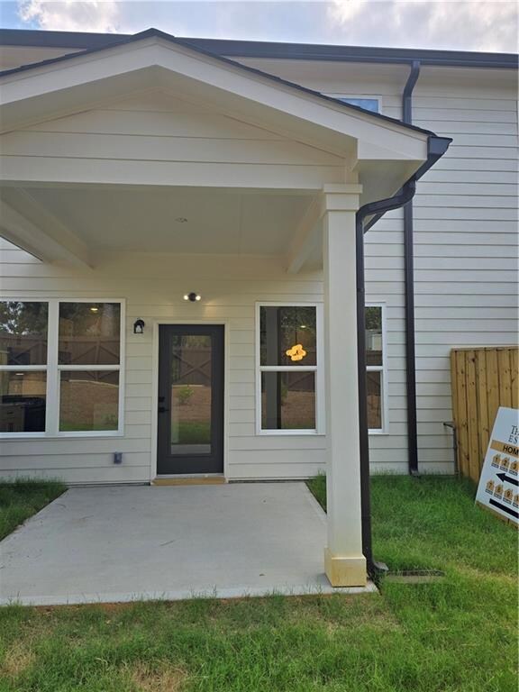 Property entrance with a patio and a yard