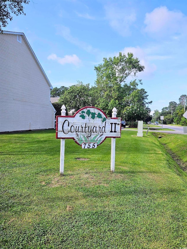 Community sign featuring a yard