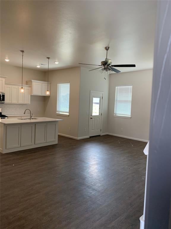 Unfurnished living room with dark wood-style floor