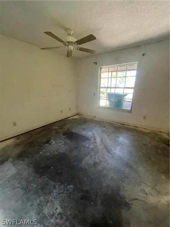 Empty room featuring a textured ceiling and ceilin