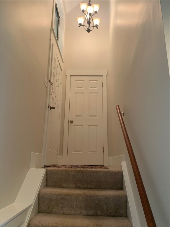 Entry with hanging chandelier.