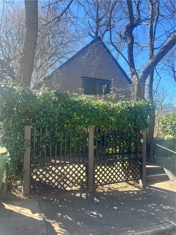 View of property exterior with a gate