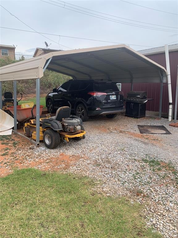 View of parking featuring a detached carport