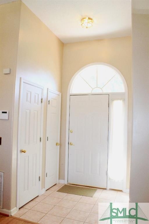Foyer with great natural light and high ceiling.