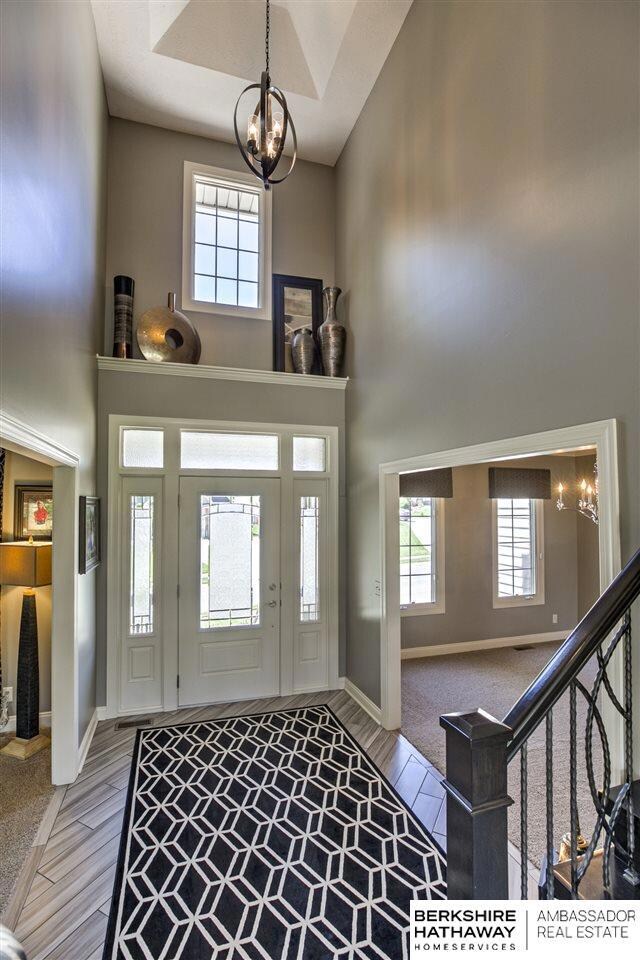Gorgeous 2 story entry.  Check out the tile floor, window coverings, and fixtures in this house.  These owners decorate like professionals.
